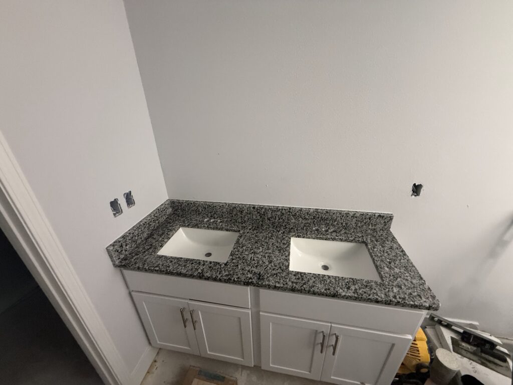 Bathroom vanity with granite countertop and undermount sink in Northeast Florida