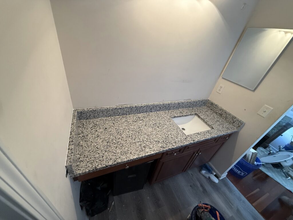 Bathroom vanity with granite countertop and undermount sink in Northeast Florida